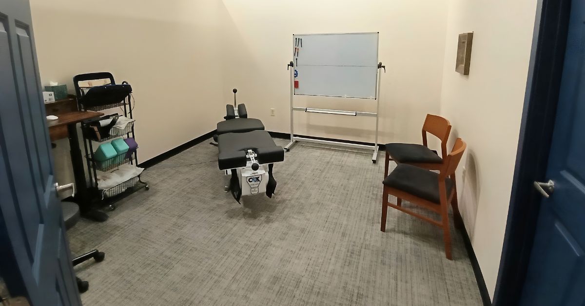 Chiropractic treatment room at Lima Area Spine + Sport, featuring a Cox Technic flexion-distraction table for chiropractic adjustments.