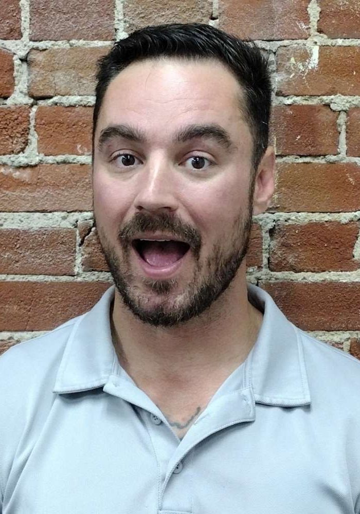 Photo of Dr. Kevin Pisle, chiropractor in Lima, Ohio laughing at his own dad joke.