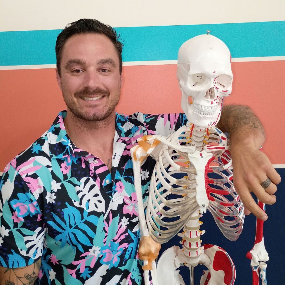 Dr. Kevin Pisle with an anatomical skeleton model, used to explain movement and spine health to patients.